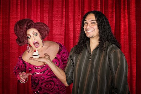 simsearch:400-07261849,k - Smiling latino man with hungry drag queen and cupcake Fotografie stock - Microstock e Abbonamento, Codice: 400-07263308