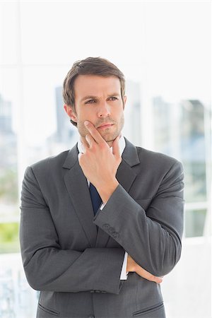 simsearch:400-07274414,k - Serious handsome young businessman standing over blurred background outdoors Photographie de stock - Aubaine LD & Abonnement, Code: 400-07274417