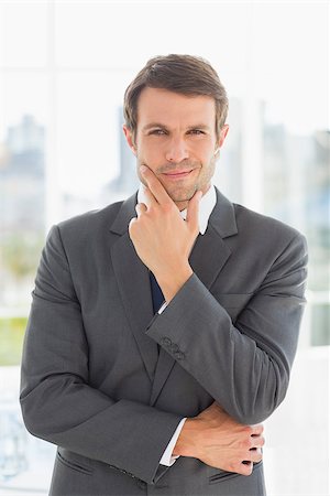 simsearch:400-07274414,k - Portrait of a young businessman standing over blurred background outdoors Photographie de stock - Aubaine LD & Abonnement, Code: 400-07274418