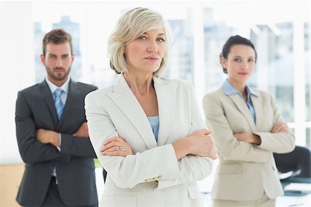 simsearch:400-06879270,k - Portrait of a confident business team standing with arms crossed in a bright office Stock Photo - Budget Royalty-Free & Subscription, Code: 400-07274452