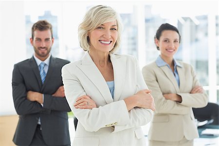 simsearch:400-07274414,k - Portrait of a confident business team standing with arms crossed in a bright office Photographie de stock - Aubaine LD & Abonnement, Code: 400-07274453