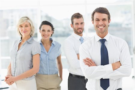 simsearch:400-07274497,k - Portrait of a confident smiling business team standing in a bright office Stock Photo - Budget Royalty-Free & Subscription, Code: 400-07274509