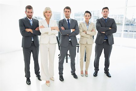 simsearch:400-07275828,k - Full length portrait of a confident business team standing with arms crossed in a bright office Photographie de stock - Aubaine LD & Abonnement, Code: 400-07274500