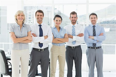 simsearch:400-07275828,k - Portrait of a confident business team standing with arms crossed in a bright office Photographie de stock - Aubaine LD & Abonnement, Code: 400-07274516