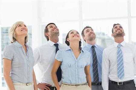 simsearch:400-07274497,k - Smiling business team looking up in a bright office Stock Photo - Budget Royalty-Free & Subscription, Code: 400-07274518