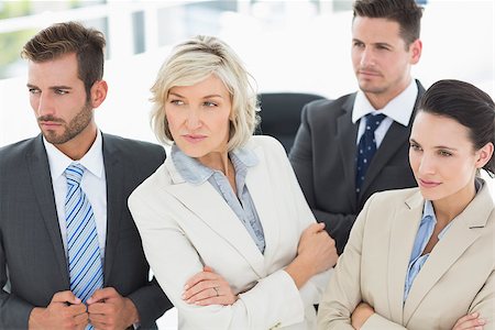 simsearch:400-07274497,k - Confident and serious business team looking away in a bright office Stock Photo - Budget Royalty-Free & Subscription, Code: 400-07274546