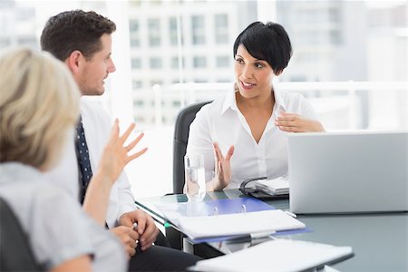 simsearch:400-07274497,k - Young well dressed business people in discussion at a bright office Stock Photo - Budget Royalty-Free & Subscription, Code: 400-07274587