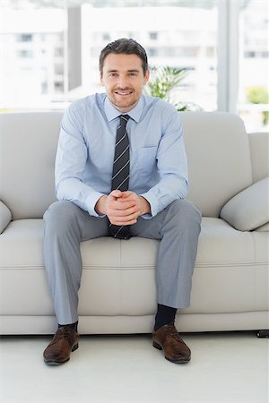 simsearch:400-07274613,k - Portrait of a well dressed relaxed young man sitting on sofa in the house Stock Photo - Budget Royalty-Free & Subscription, Code: 400-07274605