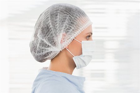 doctor with cap and mask - Closeup side view of a female surgeon wearing surgical cap and mask in the hospital Stock Photo - Budget Royalty-Free & Subscription, Code: 400-07274896