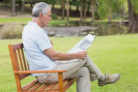 reading on park bench - Side view of a relaxed senior man reading newspaper at the park Stock Photo - Budget Royalty-Free & Subscription, Code: 400-07274908