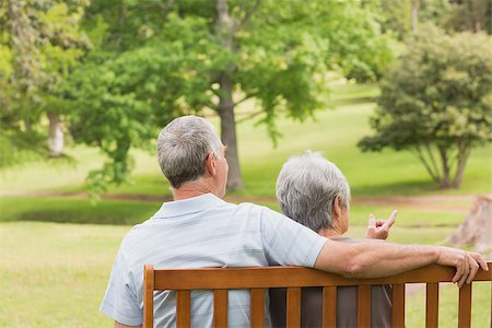 simsearch:400-07275058,k - Rear view of a senior man and woman sitting on bench at the park Fotografie stock - Microstock e Abbonamento, Codice: 400-07274935