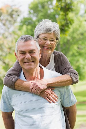 simsearch:400-07274982,k - Portrait of a senior woman embracing man from behind at the park Stock Photo - Budget Royalty-Free & Subscription, Code: 400-07274968