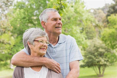simsearch:400-07274981,k - Happy senior man embracing woman from behind at the park Stock Photo - Budget Royalty-Free & Subscription, Code: 400-07274975