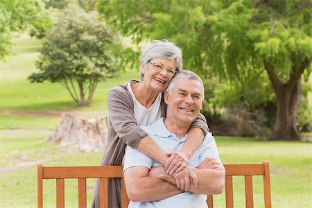 simsearch:400-07274982,k - Portrait of a senior woman embracing man from behind at the park Stock Photo - Budget Royalty-Free & Subscription, Code: 400-07274976