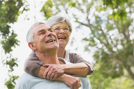 simsearch:400-07274981,k - Cheerful senior woman embracing man from behind at the park Stock Photo - Budget Royalty-Free & Subscription, Code: 400-07274970
