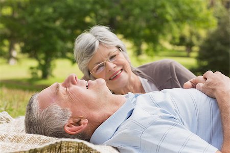 simsearch:400-07274981,k - Side of a senior woman and man lying at the park Stock Photo - Budget Royalty-Free & Subscription, Code: 400-07274991