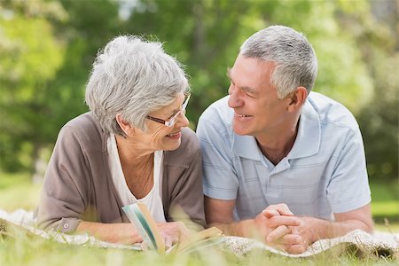 simsearch:400-07274981,k - Portrait of a smiling relaxed senior couple lying in the park Stock Photo - Budget Royalty-Free & Subscription, Code: 400-07275008