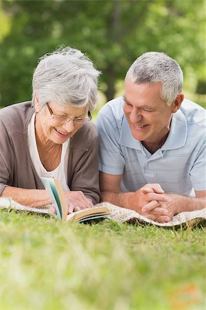 simsearch:400-07275058,k - Portrait of a smiling relaxed senior couple lying in the park Fotografie stock - Microstock e Abbonamento, Codice: 400-07275009