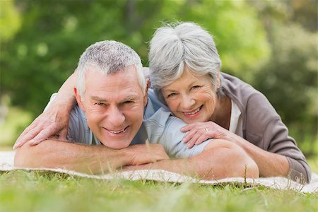 simsearch:400-07274982,k - Portrait of a smiling relaxed senior couple lying in the park Stock Photo - Budget Royalty-Free & Subscription, Code: 400-07275011
