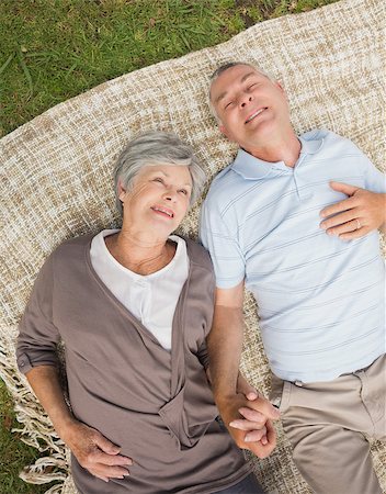 simsearch:400-07274981,k - High angle view of a smiling relaxed senior couple lying in the park Stock Photo - Budget Royalty-Free & Subscription, Code: 400-07275013