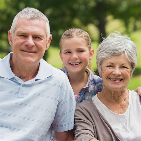 simsearch:400-07275058,k - Portrait of a smiling senior couple and granddaughter at the park Fotografie stock - Microstock e Abbonamento, Codice: 400-07275040