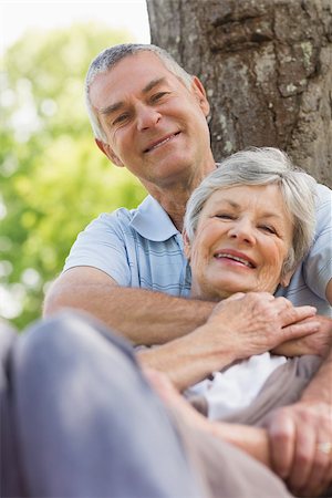 simsearch:400-07274981,k - Portrait of a happy senior man embracing woman from behind at the park Stock Photo - Budget Royalty-Free & Subscription, Code: 400-07275054