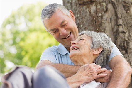 simsearch:400-07274982,k - Closeup of a happy senior man embracing woman from behind at the park Stock Photo - Budget Royalty-Free & Subscription, Code: 400-07275057