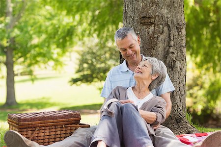 simsearch:400-07274981,k - Happy senior man embracing woman from behind at the park Stock Photo - Budget Royalty-Free & Subscription, Code: 400-07275050