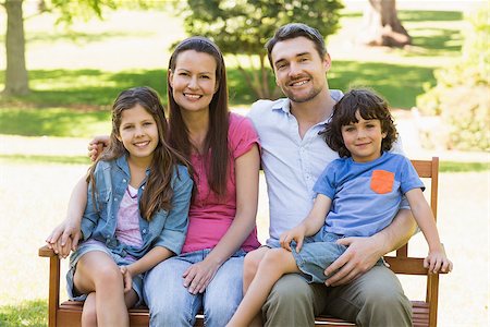 portrait of family on park bench - Portrait of a smiling couple with young kids sitting on park bench Stock Photo - Budget Royalty-Free & Subscription, Code: 400-07275190