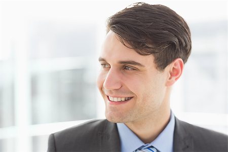 simsearch:400-07275251,k - Smiling handsome businessman looking away in the office Stock Photo - Budget Royalty-Free & Subscription, Code: 400-07275248