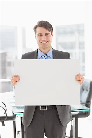 simsearch:400-07275251,k - Handsome smiling businessman holding placard in the office Stock Photo - Budget Royalty-Free & Subscription, Code: 400-07275255