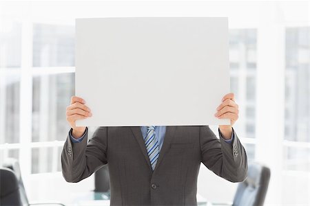 simsearch:400-07275251,k - Businessman holding placard over his face in the office Stock Photo - Budget Royalty-Free & Subscription, Code: 400-07275256