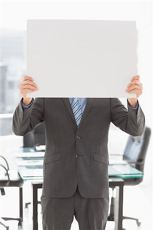 simsearch:400-07275251,k - Businessman holding poster over his face in the office Stock Photo - Budget Royalty-Free & Subscription, Code: 400-07275257