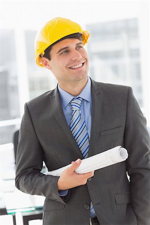 simsearch:400-07275251,k - Happy architect smiling and holding blueprints in the office Stock Photo - Budget Royalty-Free & Subscription, Code: 400-07275259