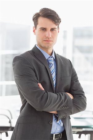 simsearch:400-07275251,k - Handsome serious businessman looking at camera in the office Stock Photo - Budget Royalty-Free & Subscription, Code: 400-07275251