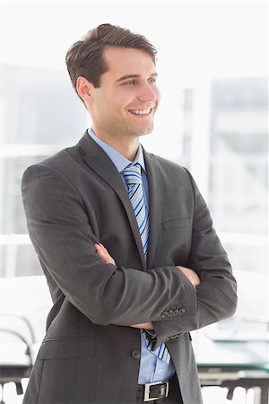 simsearch:400-07274414,k - Handsome smiling businessman with arms crossed in the office Photographie de stock - Aubaine LD & Abonnement, Code: 400-07275252