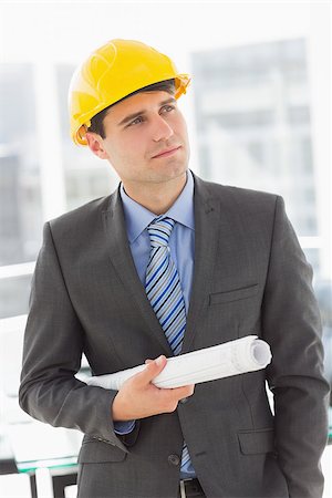 simsearch:400-07275251,k - Happy architect thinking and holding blueprints in the office Stock Photo - Budget Royalty-Free & Subscription, Code: 400-07275260