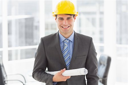 simsearch:400-07275251,k - Happy architect holding blueprints smiling at camera in the office Stock Photo - Budget Royalty-Free & Subscription, Code: 400-07275262