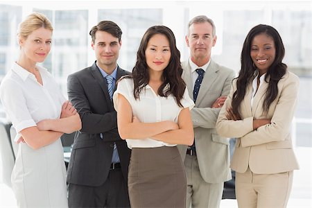 simsearch:400-07275394,k - Business team smiling at camera with arms crossed in the office Stock Photo - Budget Royalty-Free & Subscription, Code: 400-07275304