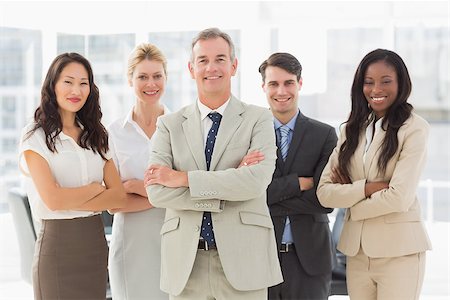 simsearch:400-06879270,k - Business team smiling at camera with arms folded in the office Stock Photo - Budget Royalty-Free & Subscription, Code: 400-07275306