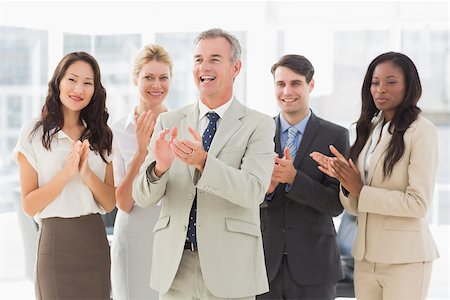 simsearch:400-07275394,k - Business team standing and clapping in the office Stock Photo - Budget Royalty-Free & Subscription, Code: 400-07275307