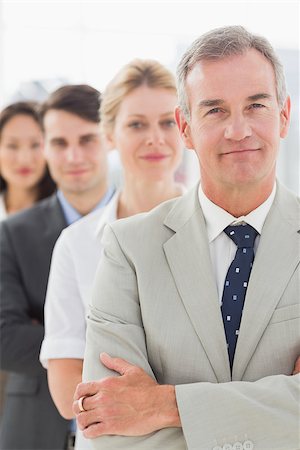 simsearch:400-07274497,k - Business team standing in a line smiling at camera in the office Stock Photo - Budget Royalty-Free & Subscription, Code: 400-07275314
