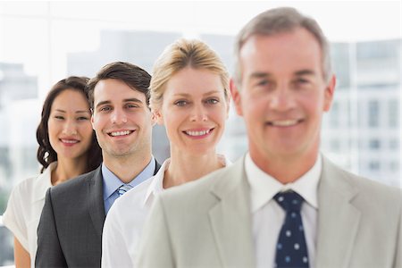 simsearch:400-07274497,k - Cheerful business team standing in a line smiling at camera in the office Stock Photo - Budget Royalty-Free & Subscription, Code: 400-07275312