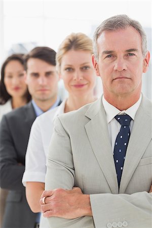 simsearch:400-07274497,k - Business team standing in a line looking at camera in the office Stock Photo - Budget Royalty-Free & Subscription, Code: 400-07275313