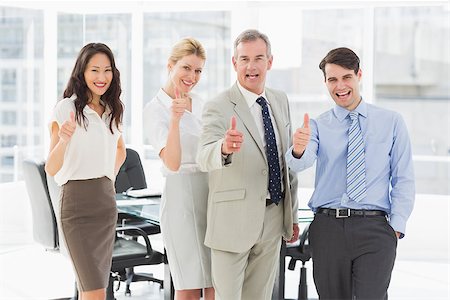 simsearch:400-07274497,k - Business team giving thumbs up to the camera in the office Stock Photo - Budget Royalty-Free & Subscription, Code: 400-07275327