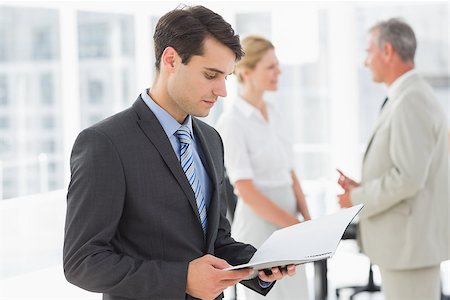 simsearch:400-06879270,k - Businessman reading over a document in the office Stock Photo - Budget Royalty-Free & Subscription, Code: 400-07275321