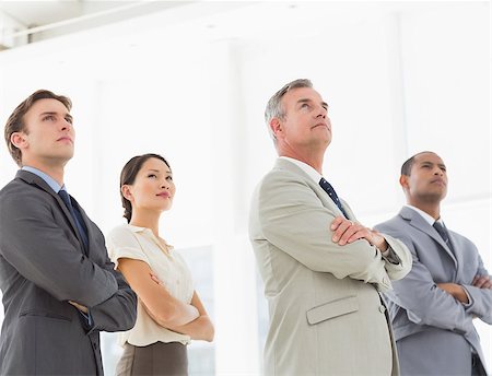 simsearch:400-07274497,k - Serious business team with arms crossed looking up in the office Stock Photo - Budget Royalty-Free & Subscription, Code: 400-07275332