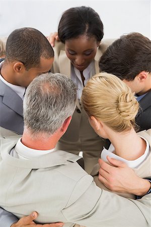 simsearch:400-07275394,k - Close business team hugging in a circle in the office Stock Photo - Budget Royalty-Free & Subscription, Code: 400-07275344