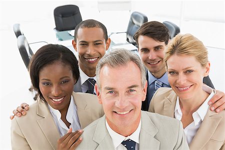 simsearch:400-07275394,k - Diverse business team smiling up at camera in the office Stock Photo - Budget Royalty-Free & Subscription, Code: 400-07275349