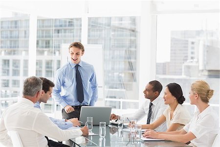 simsearch:400-07275394,k - Businessman standing in front of his team at meeting in the office Stock Photo - Budget Royalty-Free & Subscription, Code: 400-07275387